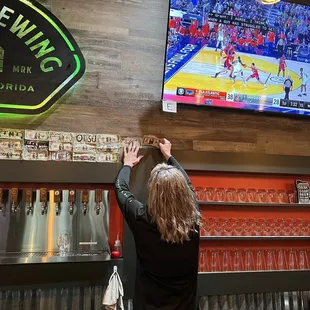 a woman reaching for a beer