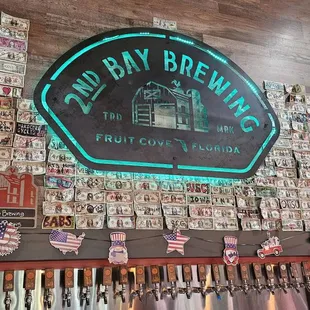 The brewery logo and their wall of taps