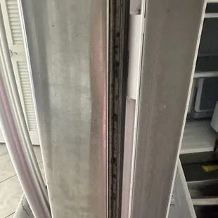 Black mold, broken hinges, and rotted seal, some roaches