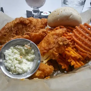 Crispy Fish and Sweet Potato Fries with coleslaw and a dinner roll.
