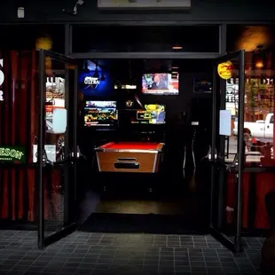 a pool table and neon signs