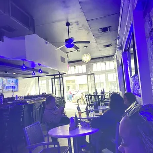 people sitting at tables in a restaurant