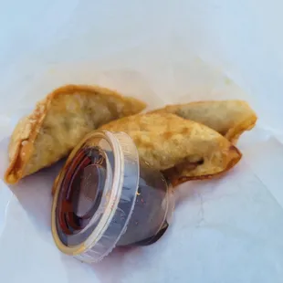 ows a closeup of a pastry with a jar of sauce