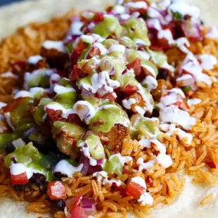 ows a taco topped with sauce and vegetables