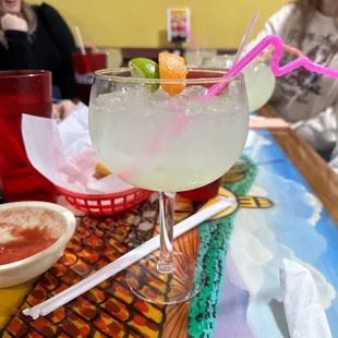 two women sitting at a table with drinks