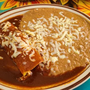 Enchiladas with beans; part of Speedy Gonzales (chicken taco next picture)