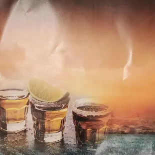 three shot glasses of beer