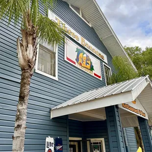 a blue building with a palm tree in front of it