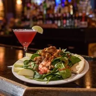a plate of salad and a cocktail