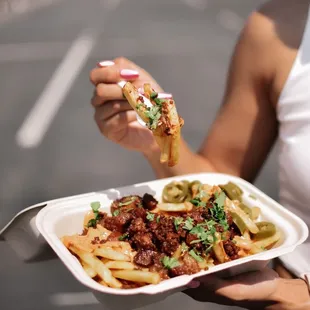 a woman holding a plate of food