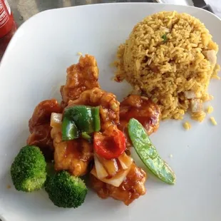 a plate of food with rice and broccoli