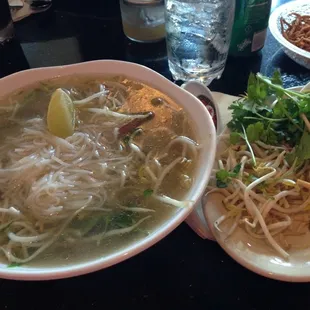 a bowl of soup and a plate of noodles