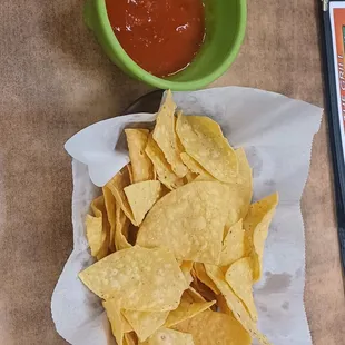 a bowl of chips and a bowl of ketchup