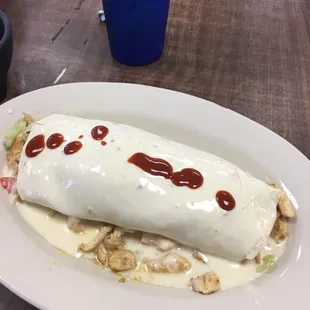 a burrito with sauce on it