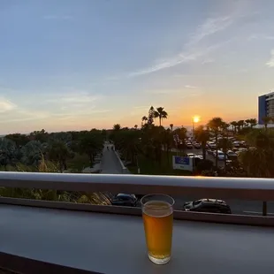 a glass of beer on a balcony