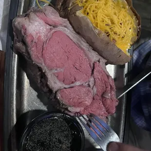 Large prime rib with baked potato