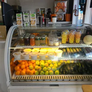 a refrigerated display case filled with fruit