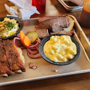 a tray of meat and sides