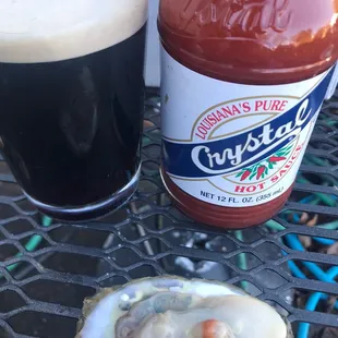 a bottle of beer and a oyster