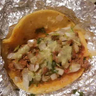 Pork and beef taco with cilantro and onions on a corn tortilla. $1.50 on a corn tortilla / $2 if you get a flour tortilla.