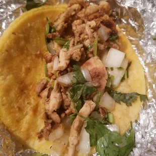 Chicken taco with cilantro and onion on a corn tortilla. $1.50 on corn / it is $2 if you request a flour tortilla.