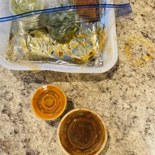 My 2 oz consume for (4) tacos next to a cup of hot sauce