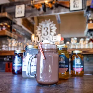 a jar of hot chocolate with a candy cane