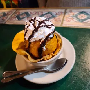 a banana split with chocolate sauce and whipped cream