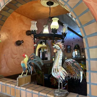 a rooster and a rooster figurine