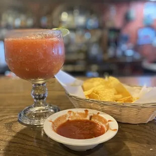 a bowl of salsa and a bowl of chips