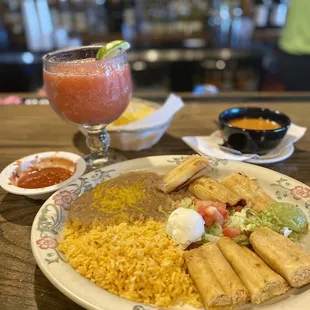 a plate of mexican food and a drink