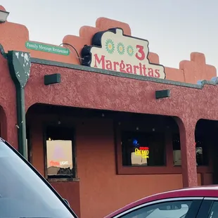 two cars parked in front of a restaurant
