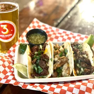 a plate of tacos and a glass of beer