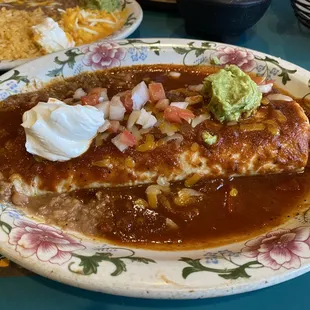 Ground beef burrito with roasted tomato sauce.