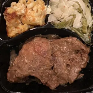 Smothered pork chops Mac and cheese and cabbage