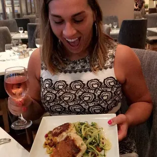a woman holding a plate of food