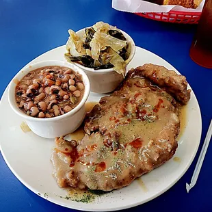 Smothered pork chops, black eyed peas, and cabbage