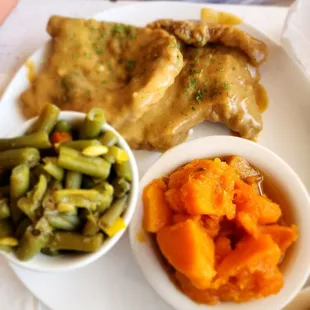 Smothered pork Chops, sweet potatoes,  green beans. Chicken fried steak with sweet potatoes and green beans.
