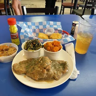 Smothered pork chops, southern greens, candied yams, cornbread, Arnold Palmer iced tea, and Sweet potato dump cake, YUMMM