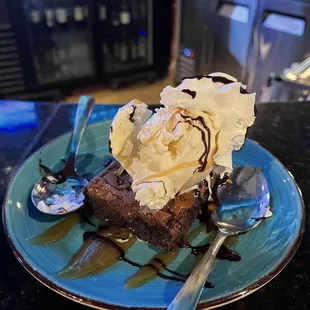 a piece of cake with ice cream and chocolate sauce