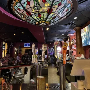 a bar with a stained glass ceiling