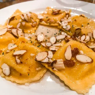 Butternut Squash Ravioli - Rossed in a mildy sweet browned butter sauce, accompanied by almonds.