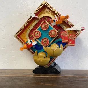 a wooden clock with chinese characters on it