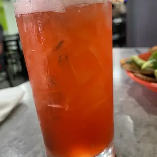 a glass of iced tea on a table