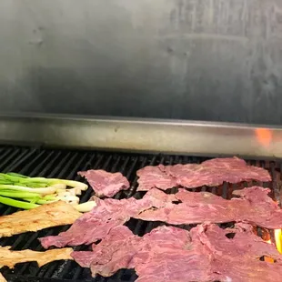 steaks being cooked on a grill