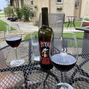 two glasses of wine and a bottle of wine