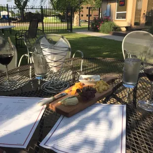 Two glasses of merlot and a cheese plate