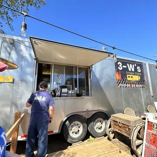 a man standing in front of a trailer