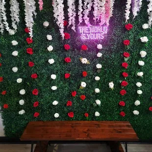 a wall of flowers and greenery