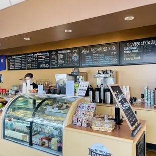 a man standing at the counter of a coffee shop